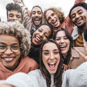 Multicultural community of young people smiling together at camera